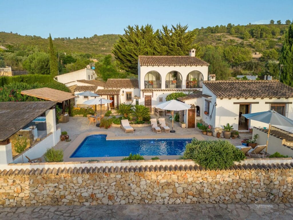 Sunny white villa of Casa Llibertat B&B with terrace and pool.